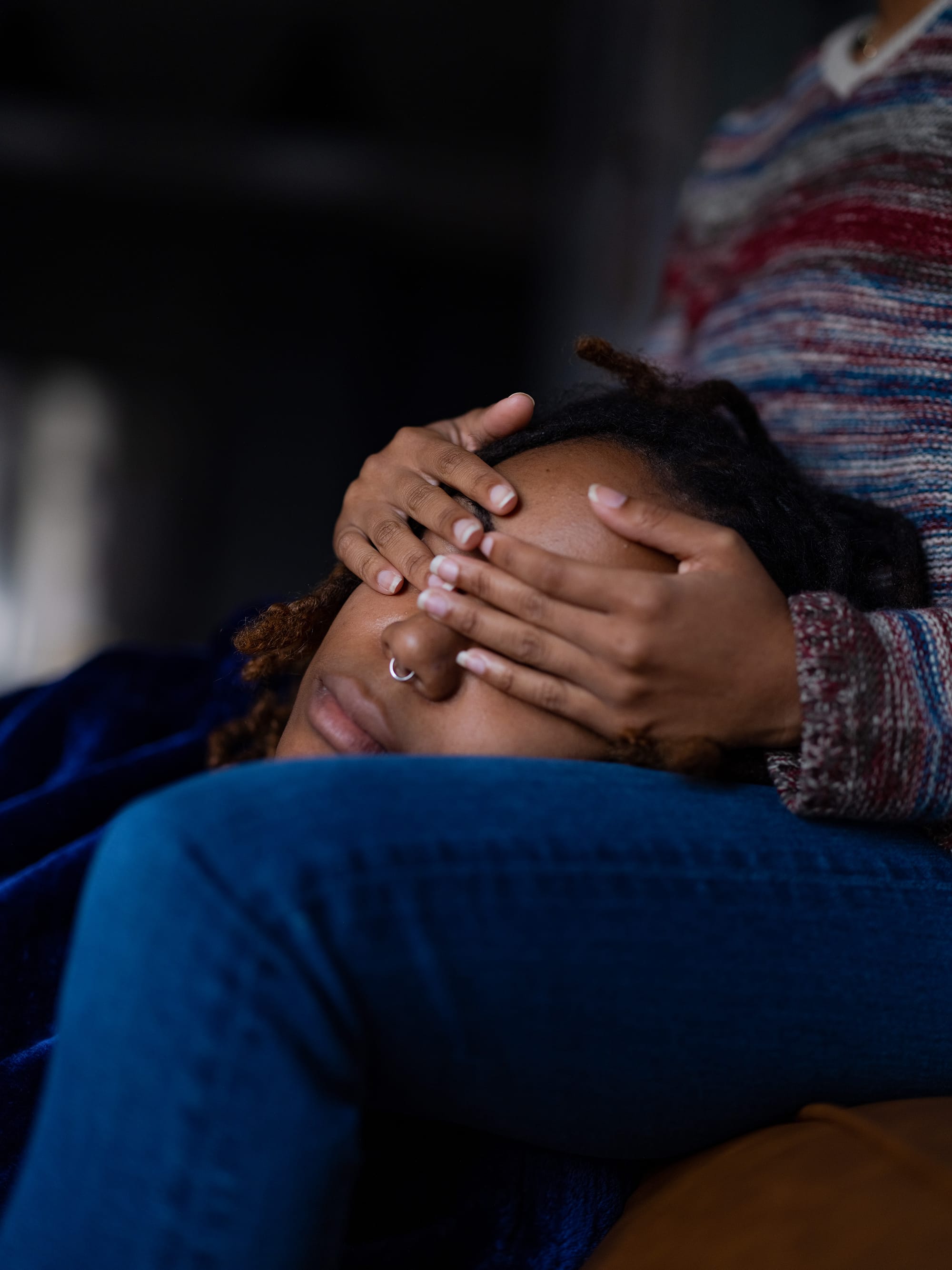 A woman's vision is obscured by two hands held over her eyes.