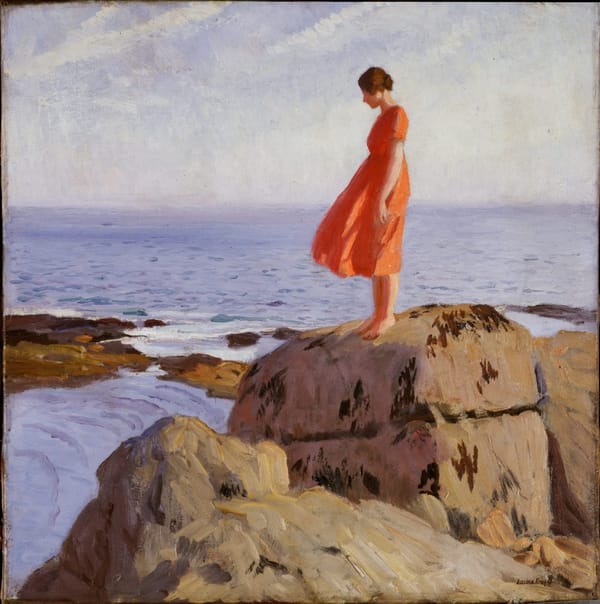 The 1917 painting by Laura Knight, shows a woman in an orange dress standing on rocks, looking down at the ocean.