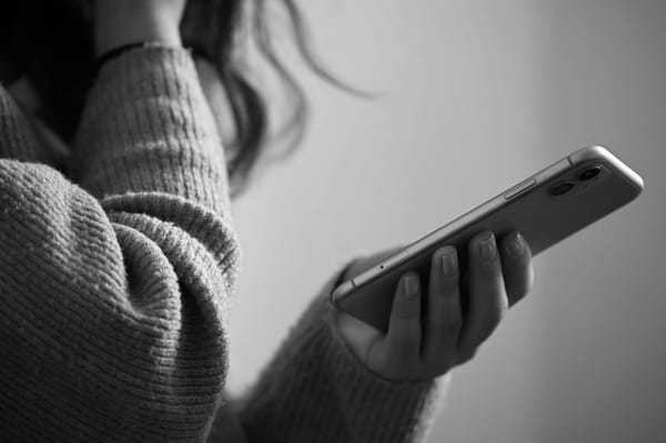 Close up of a hand holding a smartphone.